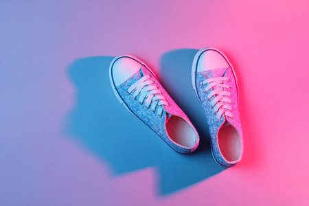 Fashionable sneakers neon pink blue light. Retro style 80s, minimalismの写真素材