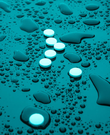Drug concept, addiction. Pills on dark background with water drops. Night life. Blue neon lightの写真素材