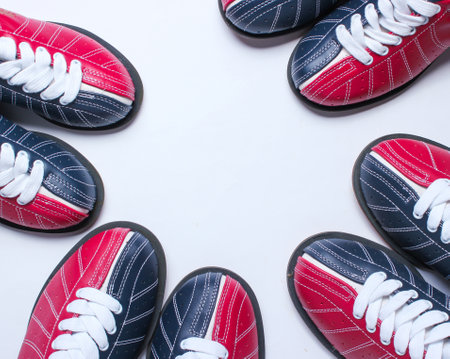 Many bowling shoes on a white background. Entertainment for groups of friends. Copy space. Top viewの写真素材