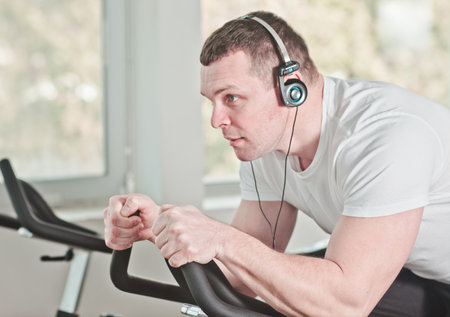 Healthy lifestyle concept. Close up portrait Young sporty man in white t-shirt and shorts is...