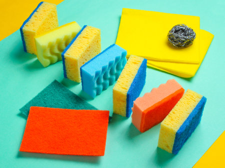 Home and bathroom cleaning kit on blue background. Sponges, abrasives.の写真素材