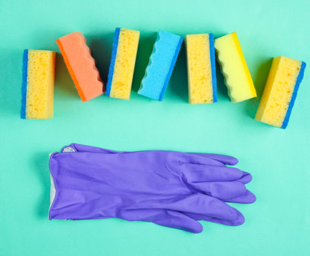 Home and bathroom cleaning
 kit on blue background. Sponges, abrasives, rubber gloves.の写真素材