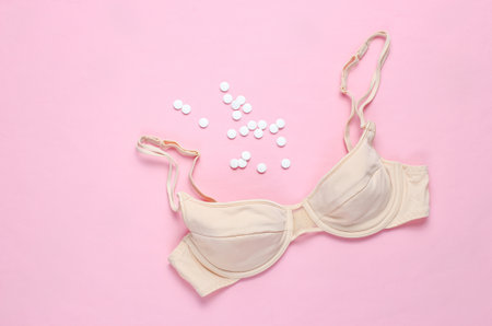 Bra and Blister contraceptive pill on pink background. Top view. Love conceptの写真素材