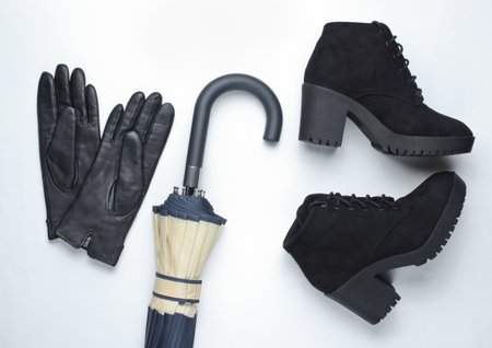Autumn women's accessories. Leather gloves, umbrella, boots on a white background. Top view.の写真素材