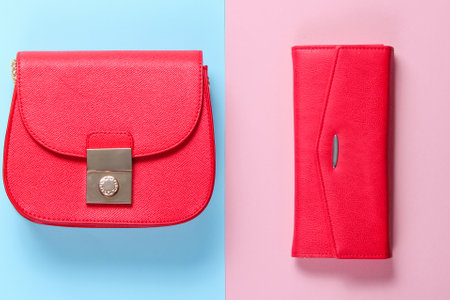 Fashion minimalism. Small yellow bag, leather wallet on a colored paper background. Top viewの写真素材