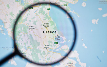 UKRAINE, ODESSA - APRIL 25, 2019: Greece on google maps through magnifying glass
