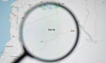 UKRAINE, ODESSA - APRIL 25, 2019: Syria on google maps through magnifying glassのeditorial素材