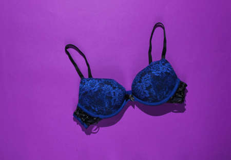 Sexy female bra on purple background. Beautiful underwear. Top viewの写真素材