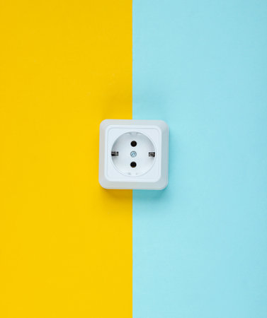 White plastic power socket on pastel background. Minimalism