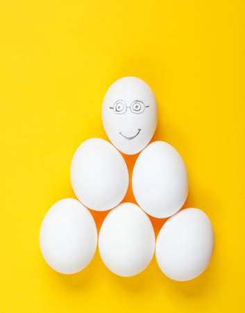 Financial pyramid concept. eggs on yellow background. Top viewの写真素材