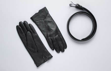 Women's fashion accessories leather belt, gloves on gray background. Top viewの写真素材