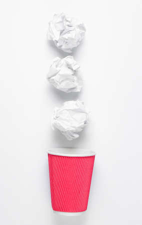 Office business concept. Paper balls, empty coffee cup on white background.の写真素材