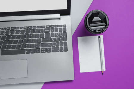 Workspace minimal concept. Notebook, sheet of paper with a pencil, cardboard container of coffee on...