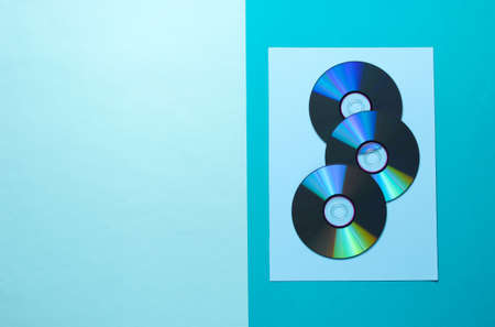 A lot of CDs on a blue background. Top view