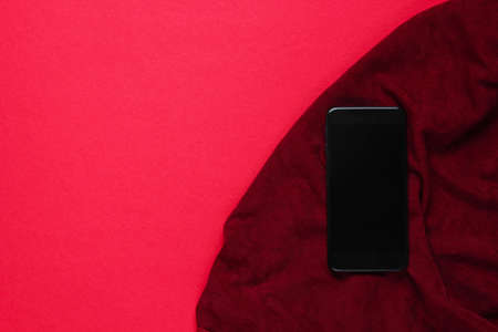 Smartphone on silk fabric. Top view. Copy spaceの写真素材