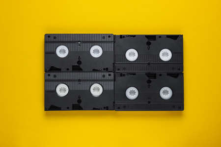 A lot of video tapes on yellow background. Top viewの写真素材