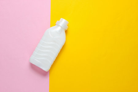 Bottle of washing gel on a pastel colored background. Top view. Minimalism