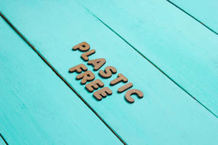 Plastic free concept. Blue wooden background with text plastic freeの写真素材