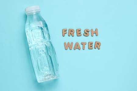 Bottled water on blue background with the words fresh water.
