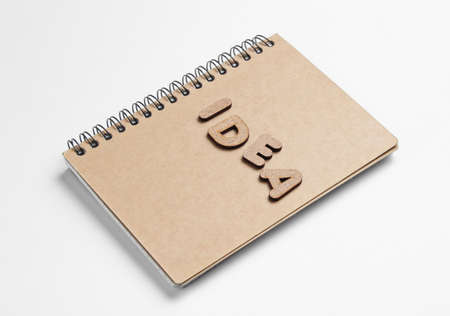 I have an idea! Notebook with craft paper with word idea on white background.の写真素材