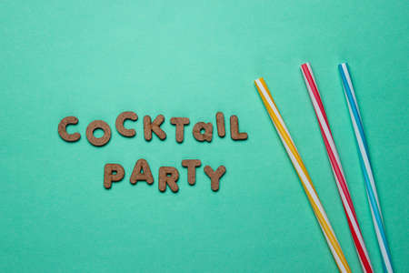 Cocktail tubes on a blue background with the slogan of a cocktail party of wooden letters.の写真素材