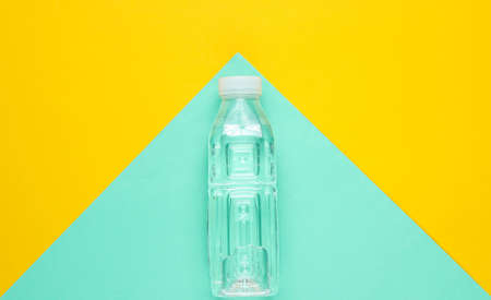 Minimalistic fitness concept. Bottle of water on colored paper background. Top viewの写真素材