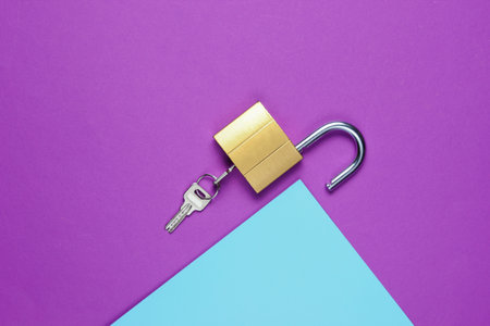 Lock and key on purple-blue background. Minimalistic concept. Top viewの写真素材
