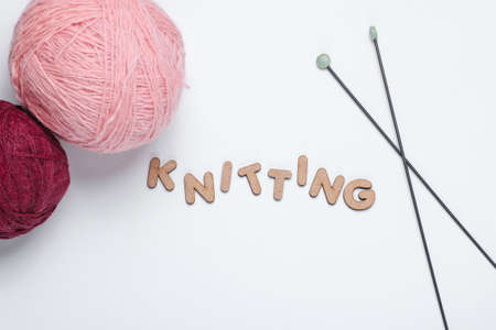 Home hobbies concept. Wool balls of thread, knitting needles on a white backgroundの写真素材