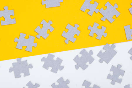Many elements of a puzzle on yellow white backgroundの写真素材