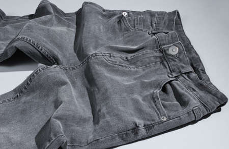 Minimalism fashion concept. Gray trend jeans on gray backgroundの写真素材