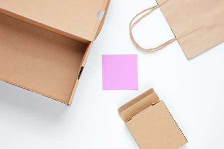 Eco concept. Cardboard boxes, paper bag, memo sheet on white background. Top viewの写真素材
