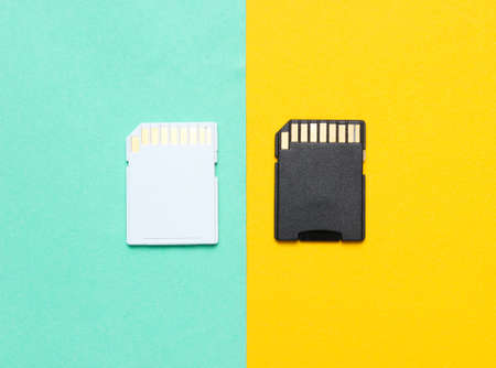 Two Mini SD memory cards on blue yellow background close upの写真素材