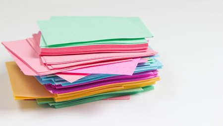 Many colored memo sheets of paper on a white backgroundの写真素材
