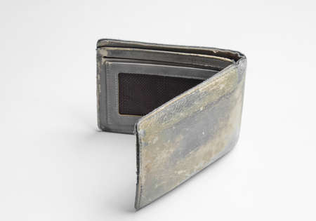 Old shabby leather wallet on a white background
