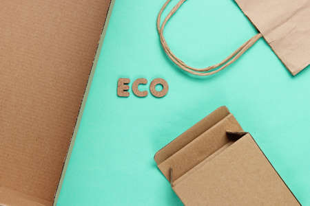 Eco concept. Cardboard boxes, paper bag on blue background. Top viewの写真素材