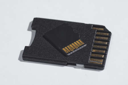 Micro SD memory card with adapter on white background close up