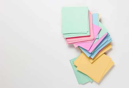 Many colored memo sheets of paper on a white backgroundの写真素材