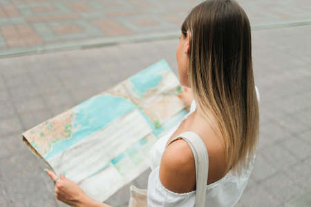 Woman tourist explore city map outdoor. Top viewの写真素材