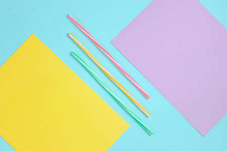 Cocktail tubes on a colored paper background. Minimalistic Cocktail Concept