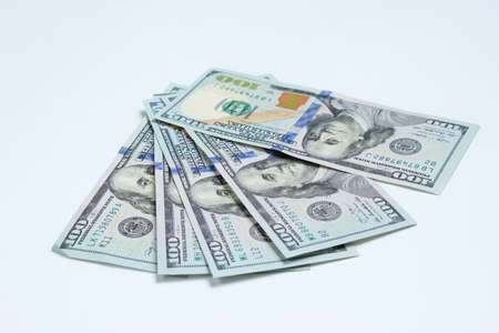 Hundred dollar bills on a white background. Minimalistic financial concept