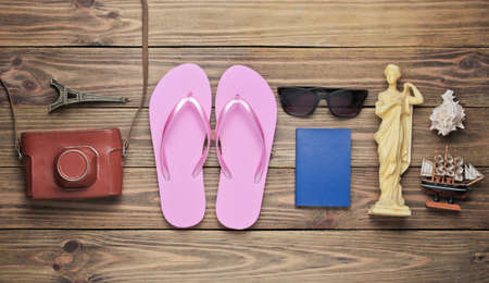 Tourism concept. Traveler background. Travel around the world, flat lay style. Tourist accessories, souvenirs on wooden background. Top viewの写真素材