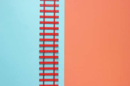 Toy railway on a pastel background. Cargo transportation, metaphor. Industrial minimalistic background. Logistics. Top viewの写真素材