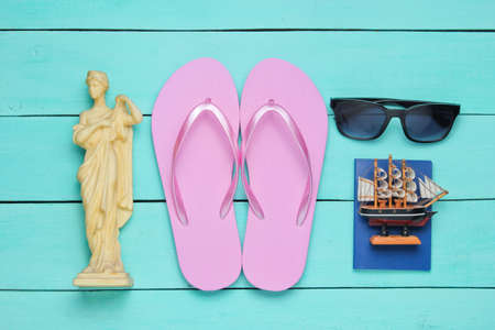 Tourism concept. Traveler background. Travel around the world, flat lay style. Tourist accessories, souvenirs on a blue wooden background. Top viewの写真素材