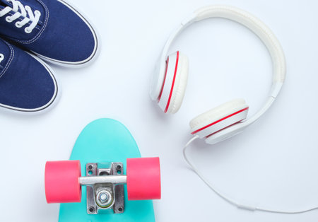Hipster fashion look. Skate, sneakers, headphones on a white background. Top view. Flat layの写真素材