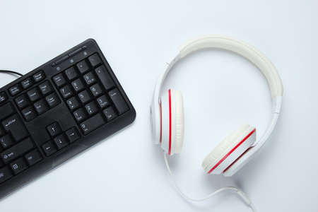 Gaming equipmen. Keyboard and headphone on white background. Music concept. Computer game competition. Top viewの写真素材