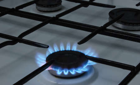 Burning burner of a gas stove close-up. Gas consumption concept