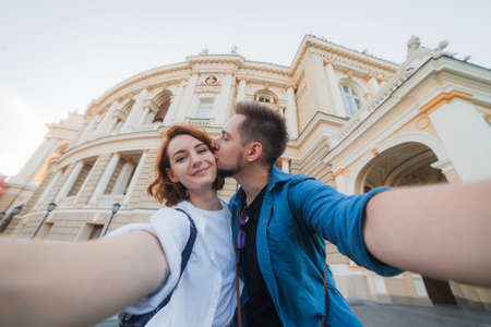 Young hipster couple in love makes selfie portrait in the city. Travel concept. Summer tourismの写真素材