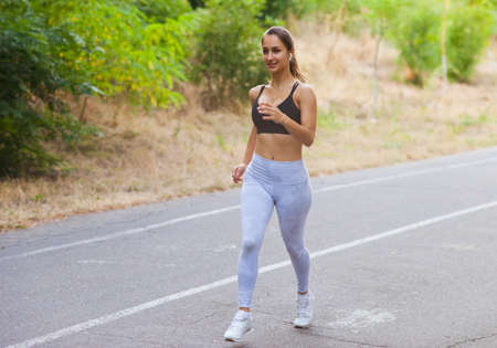 Healthy lifestyle concept. Morning running. Young woman running outdoors