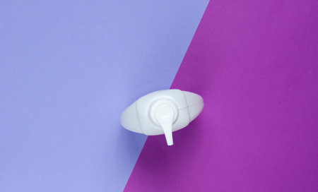 Bottle of liquid soap on a two-ton paper background. Shower gel, shampoo. Top viewの写真素材
