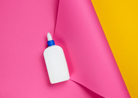 Bottle of glue on a color studio paper background. Top viewの写真素材